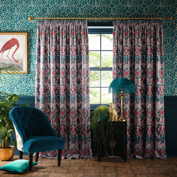 Colourful curtains against teal patterned walls