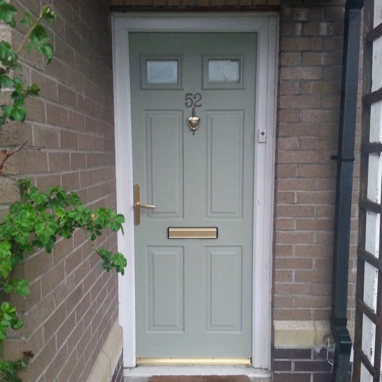 Front door painted in green grey