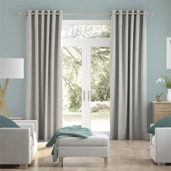 Elegant grey curtains with light blue walls