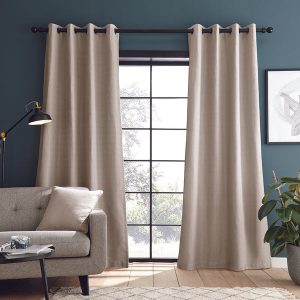 Beige curtains in a room with dark blue walls