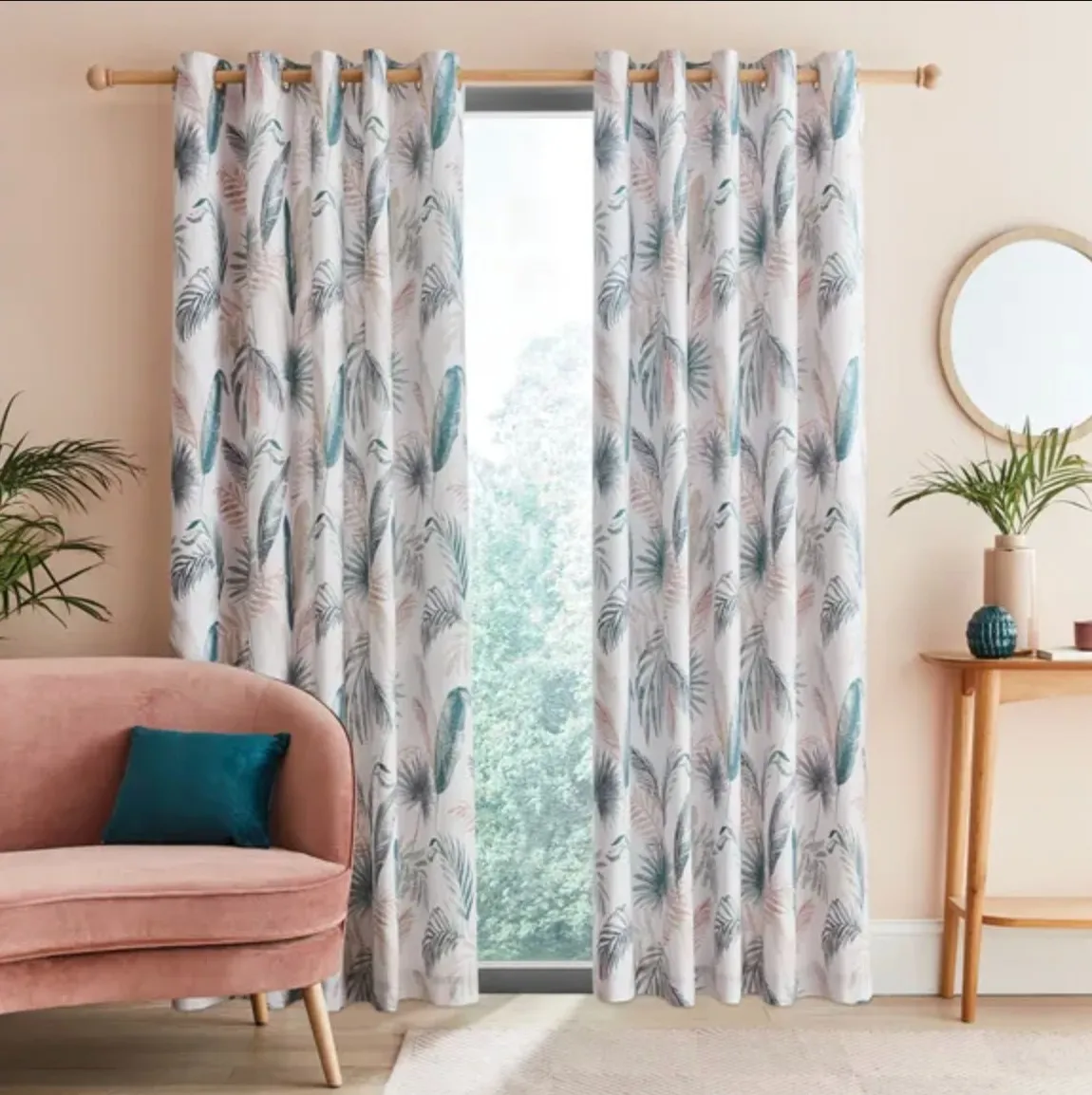 Teal and white curtains against a peachy pink wall