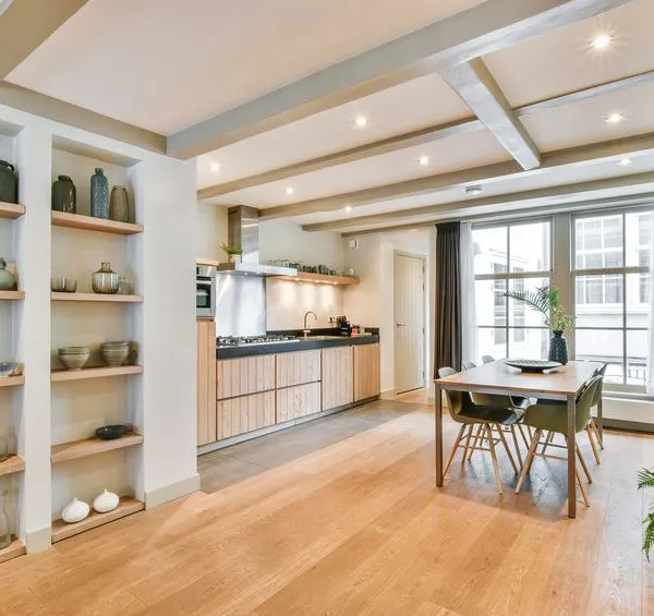 A large kitchen room with a dining table and Polyflor flooring