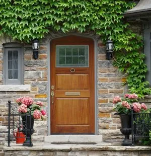 stone house with an arched wooden front door