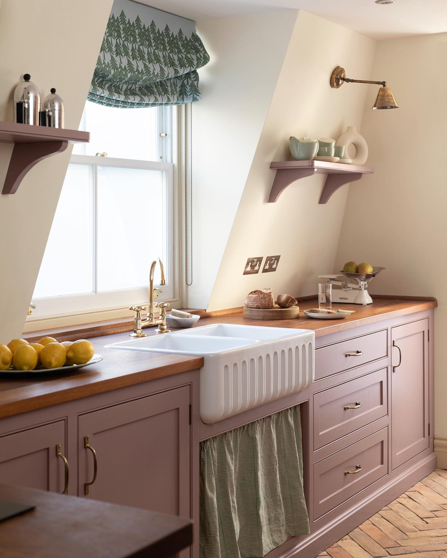 Traditional kitchen with cabinets painted in sulking room pink and walls in new white by farrow and ball