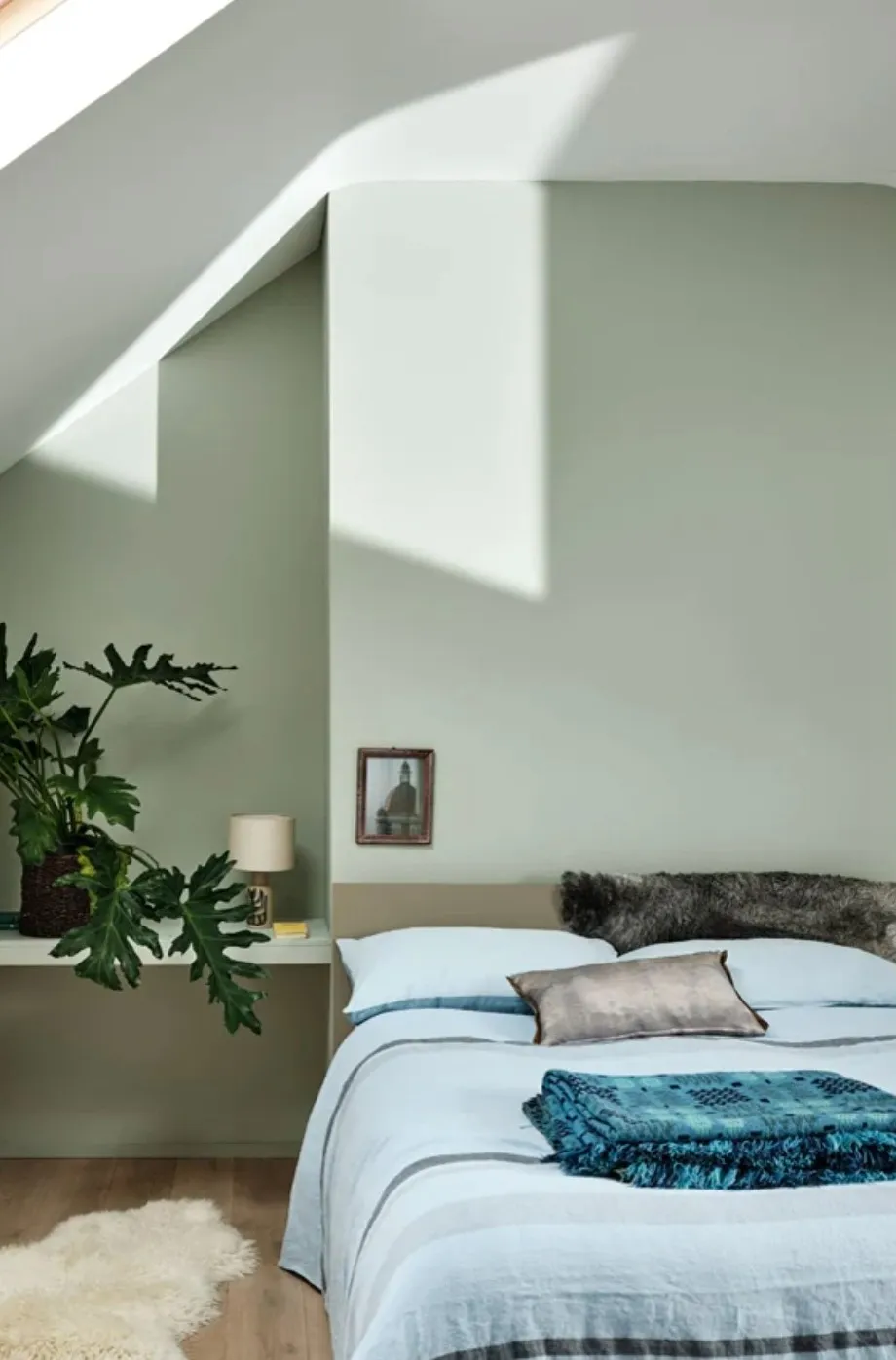 Bedroom painted in a warm sage green paint colour