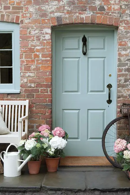 Brick house with a front door painted in duck egg blue