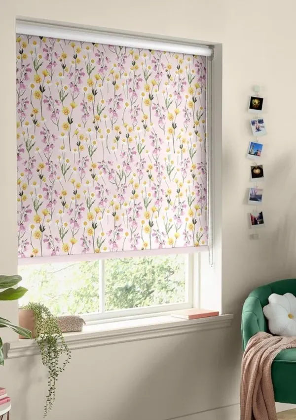 Pink floral collar blind in a modern bedroom with a green velvet armchair