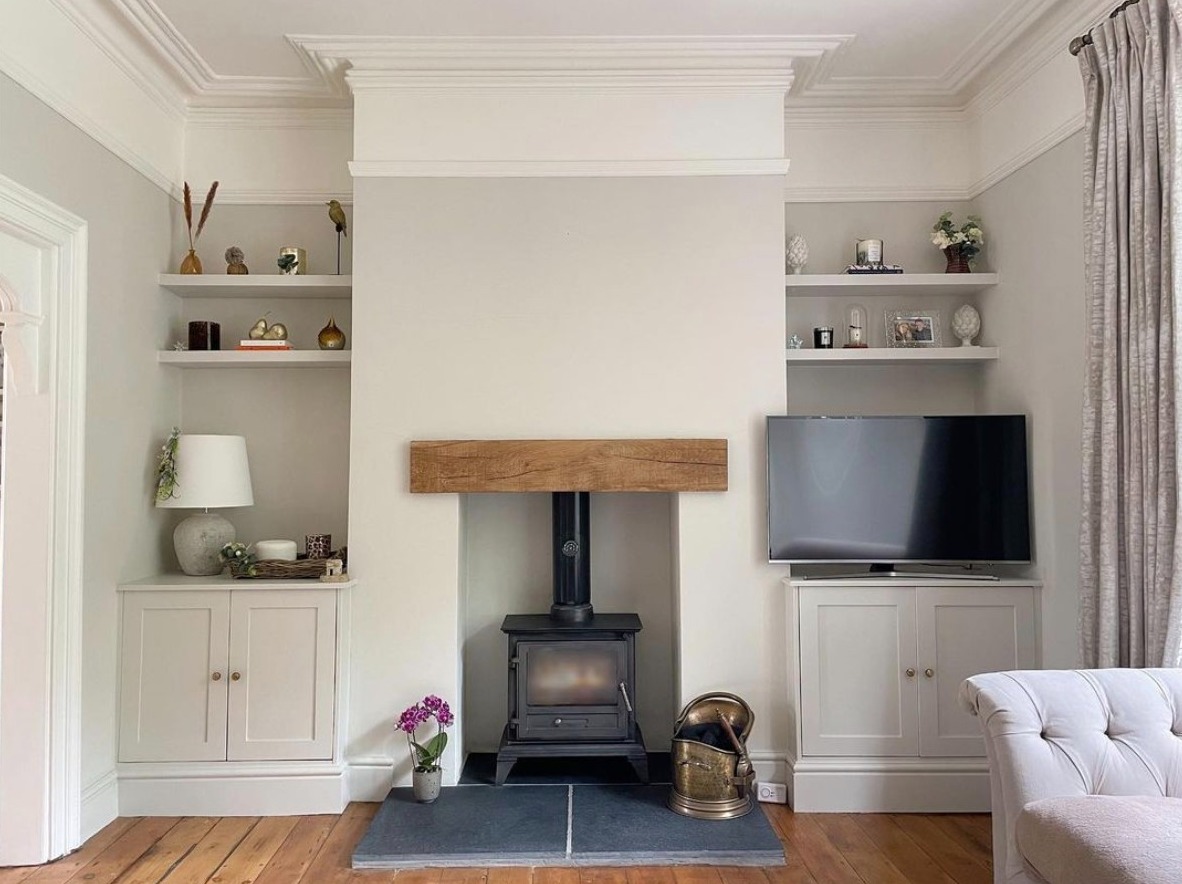 Living room with log burner painted in ammonite by farrow and ball