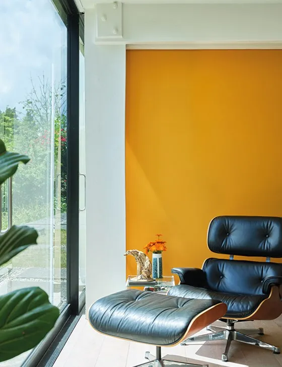 Office with a bright orange feature wall