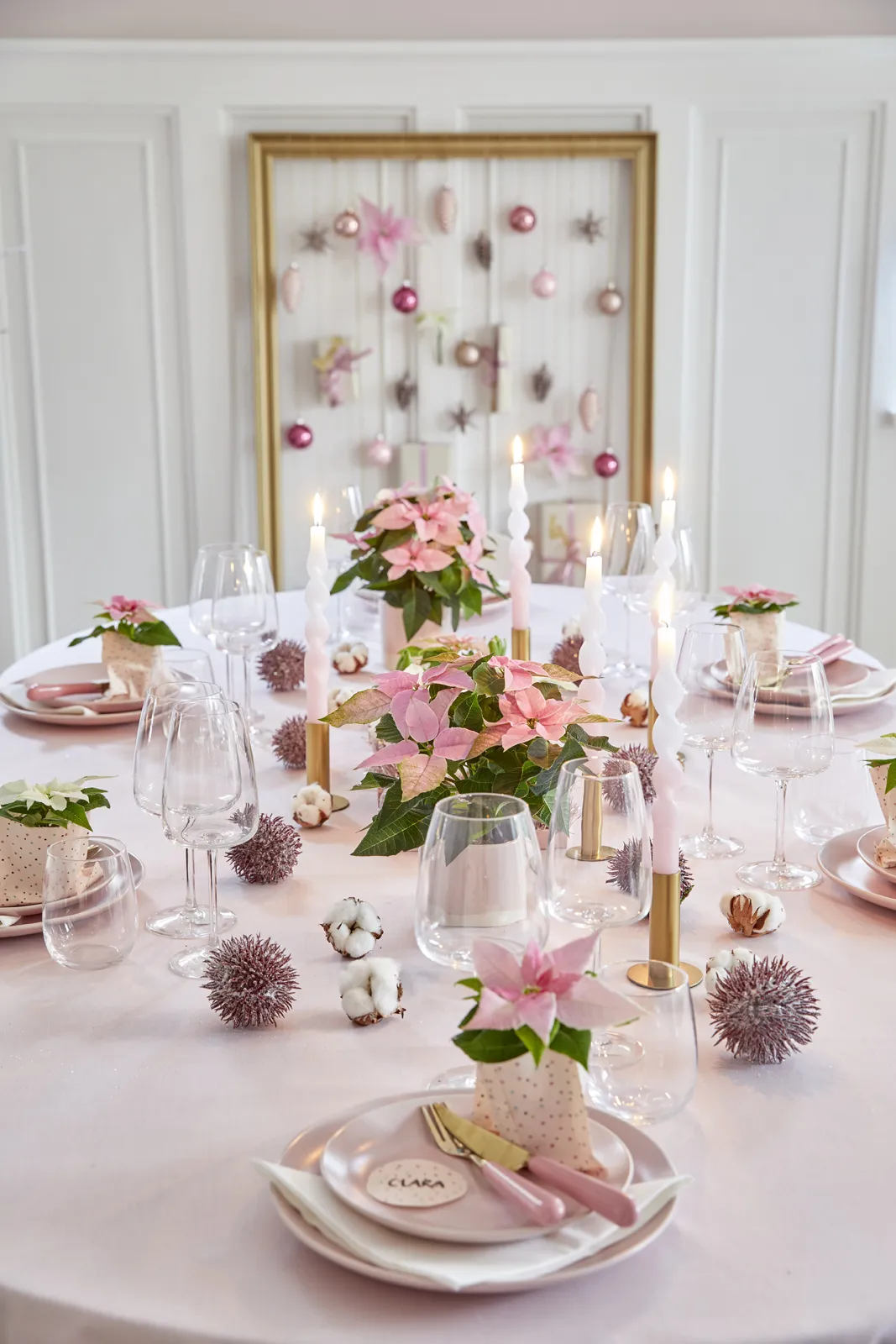 Elegant Pink and white christmas table decor with poinsettias and candles