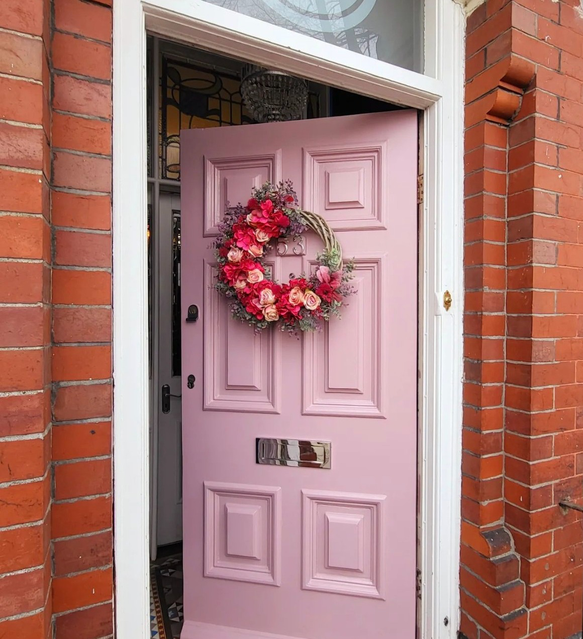 Brick house with a pink front door