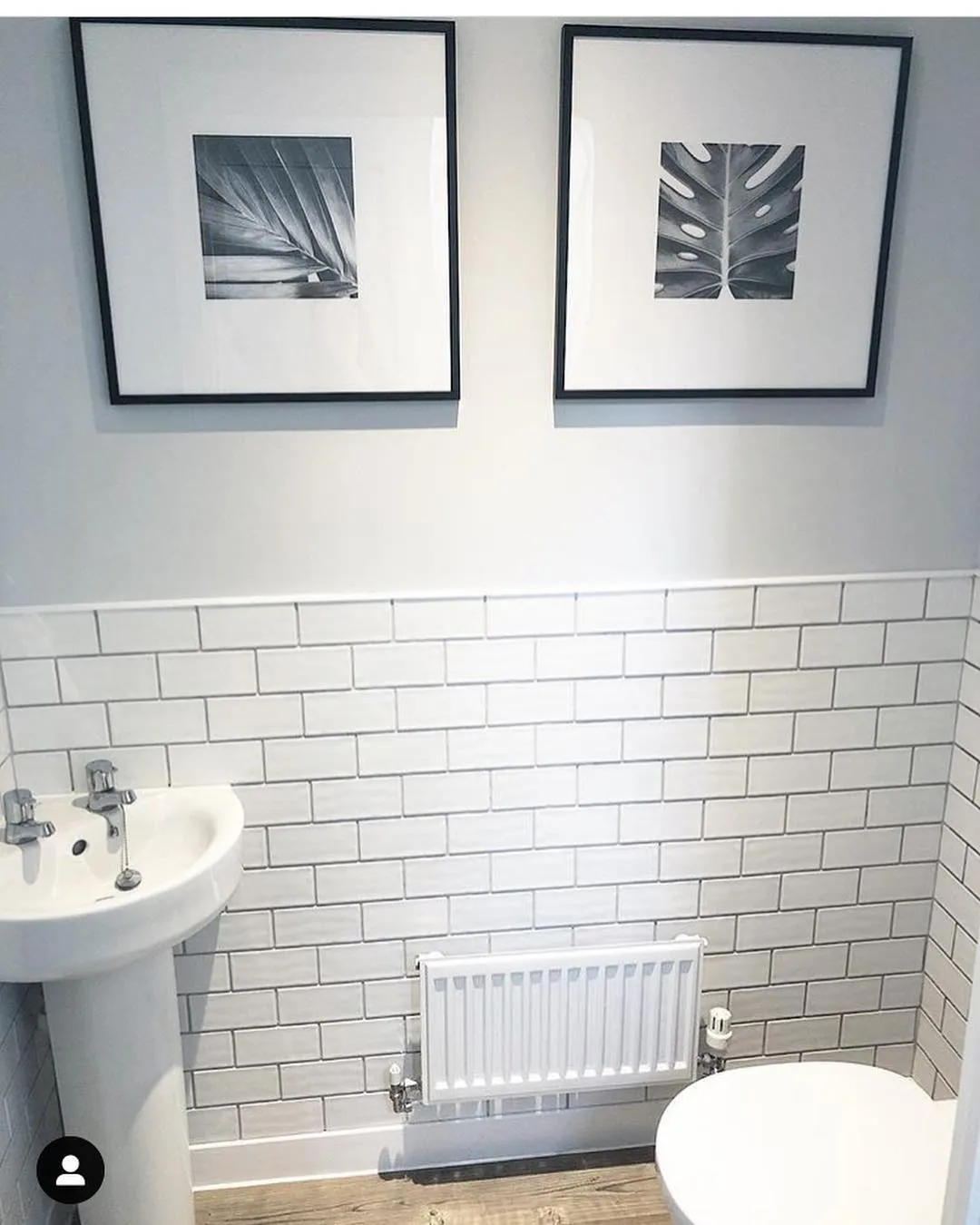 A modern downstairs loo with zellige subway tiles on the bottom half of the walls, and Farrow and Ball Blackened on the top half 
