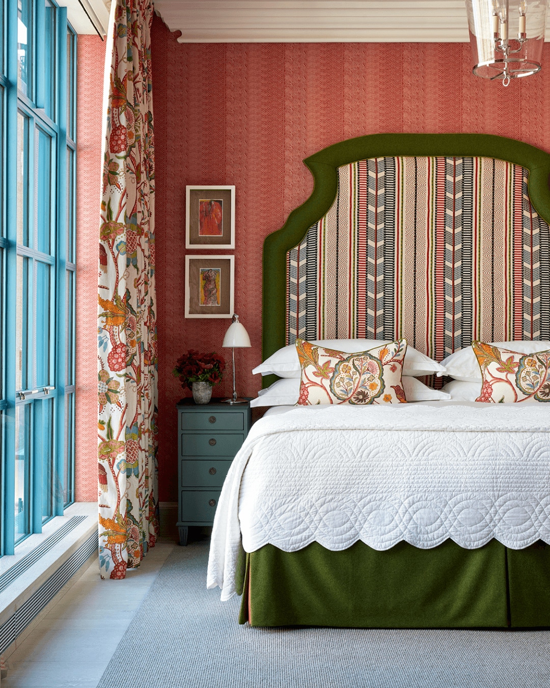 An oversized headboard upholstered in a striped patterned fabric 